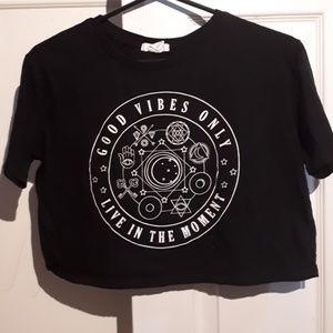 A black crop top with symbals on it